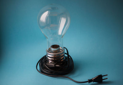 Close-up of light bulb on blue background