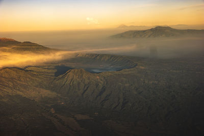 Aerial view of volcanic landscape against sky during sunset