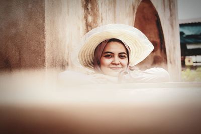 Portrait of young woman in hat