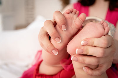 Close-up of hands holding baby hand