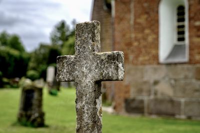 Close-up of old cross in cemetery