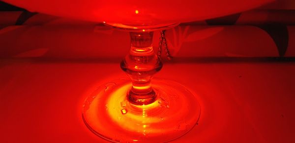 Close-up of illuminated lamp on table