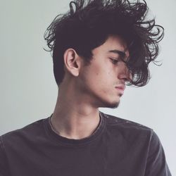  young man with messy hair against white background