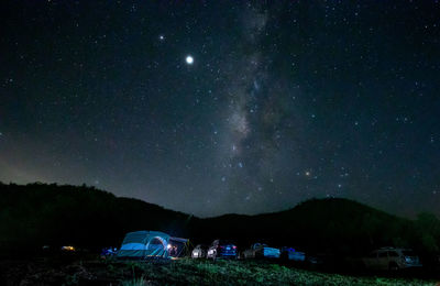 Scenic view of mountains against sky at night