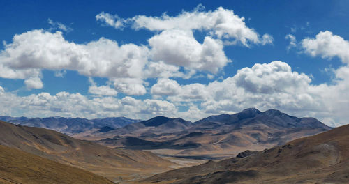 Scenic view of mountains against cloudy sky