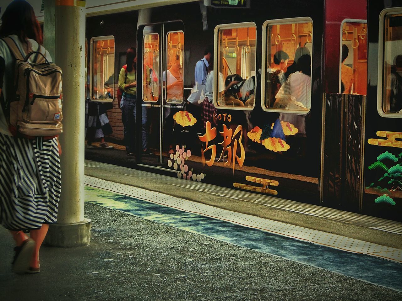 Train and people at railroad station platform