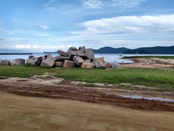 Rocks on beach against sky