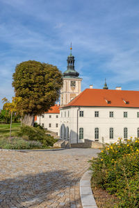 View of trees and buildings against blue sky