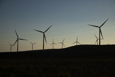 Spain, andalusia, wind turbines at dusk
