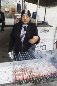 Man preparing food on street at market