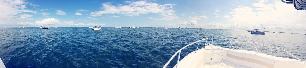 Boats sailing in sea against sky