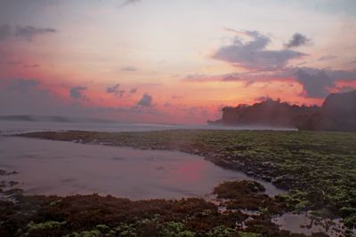 Scenic view of sea against sky at sunset