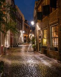 Street amidst buildings in town at night