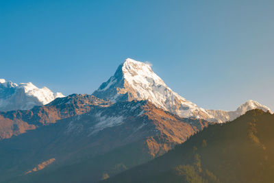 Machapuchare mountain peak in the himalaya range, seen from poon hill hiking trail in pokhara, nepal