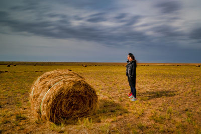 Full length of man standing on field against sky