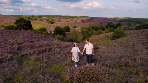 Rear view of people walking on mountain