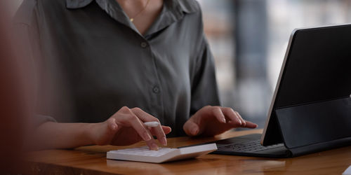 Close up view of bookkeeper or financial inspector hands making report, calculating