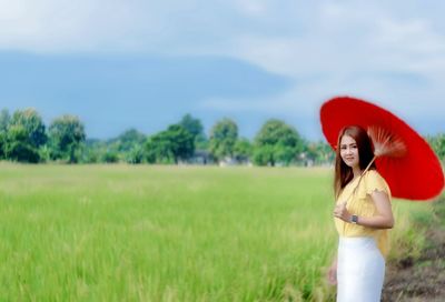 Portrait of woman standing on field