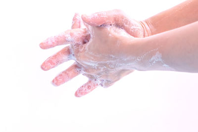 Close-up of woman hand over white background