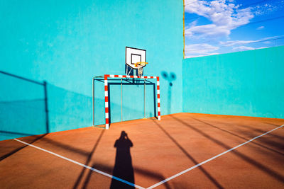 View of basketball hoop against blue sky