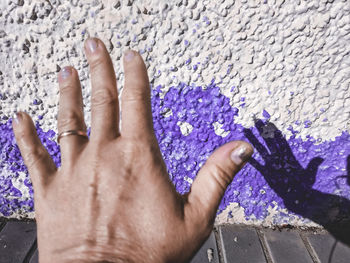 High angle view of human hand on wall