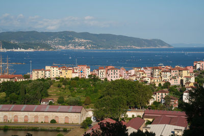 High angle view of townscape by sea against sky