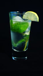 Close-up of leaf over black background