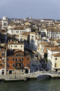 High angle view of buildings by sea against sky