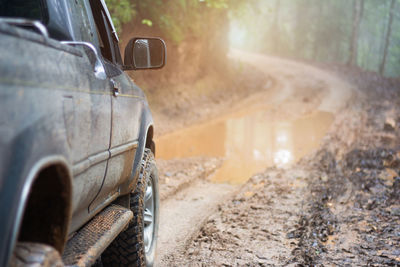 Muddy off-road vehicles, off road trip on mountain road sunset beautiful nature