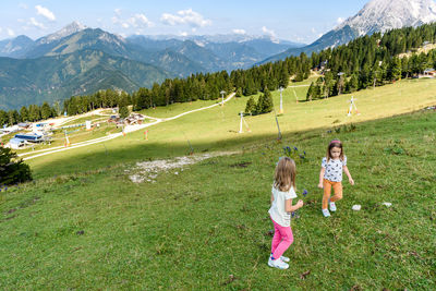 Girls playing on green mountain