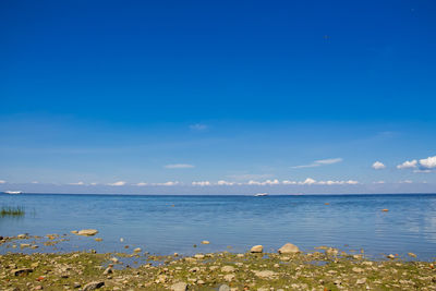 Scenic view of sea against blue sky