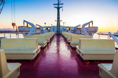 Boats moored at harbor against sky