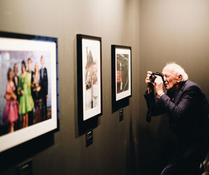 Side view of man photographing at home