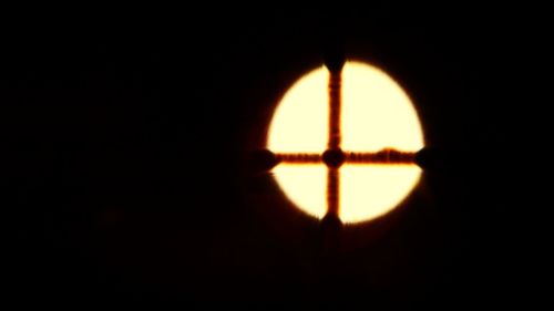 Close-up of silhouette illuminated against black background