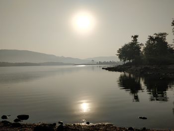 Scenic view of lake against sky during sunset