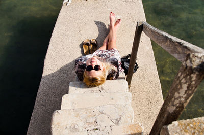 High angle view of person sitting on old steps