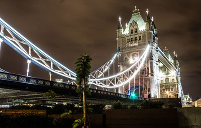 Low angle view of suspension bridge at night