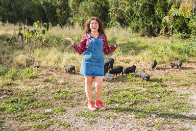 Full length of young woman standing on field