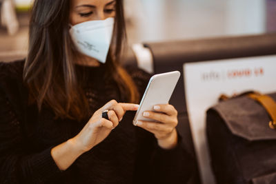 Midsection of woman using mobile phone