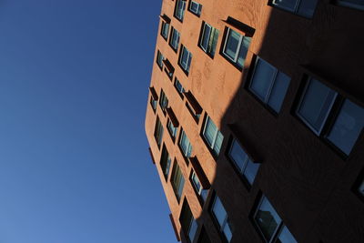 Low angle view of building against clear blue sky