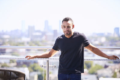 A portrait of a man with a view of the city.