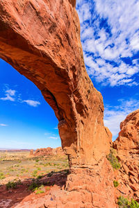 View of rock formation against cloudy sky