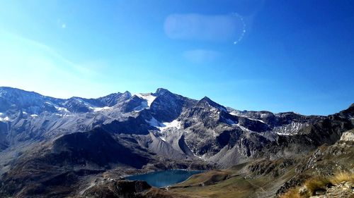 Scenic view of snowcapped mountains against clear blue sky