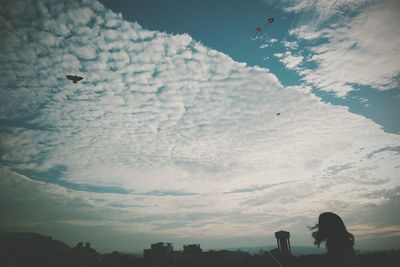 Low angle view of birds flying against sky