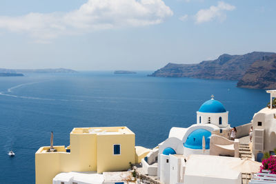 High angle view of sea by buildings against sky