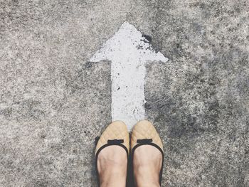 Low section of man standing on road