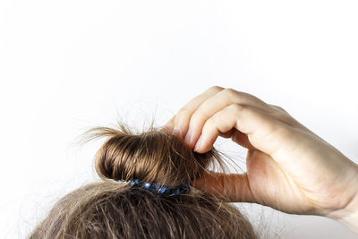 Close-up of woman hand over white background