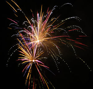 Low angle view of firework display at night