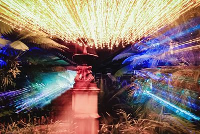 Low angle view of illuminated light trails at night