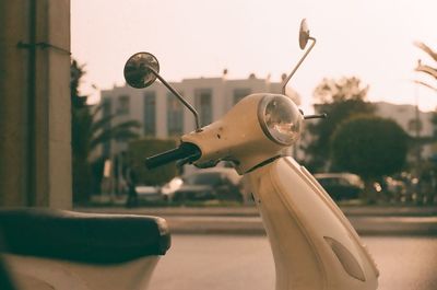 Close-up of motorcycle on street against sky